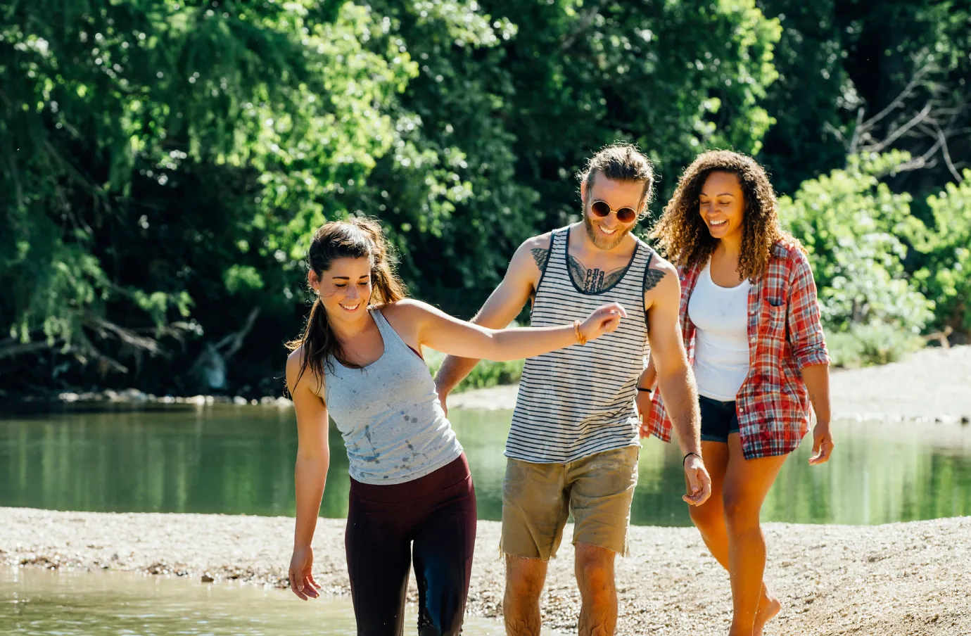 friends wading in river at greenbelt with travel insurance for Texas
